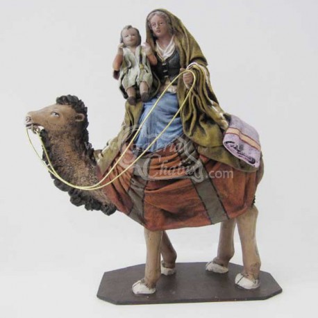 Pastora en camello con niño